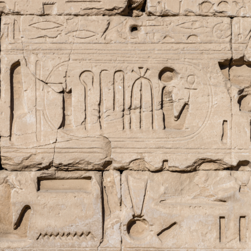 Ancient reliefs showing pharaohs who expanded Karnak Temple