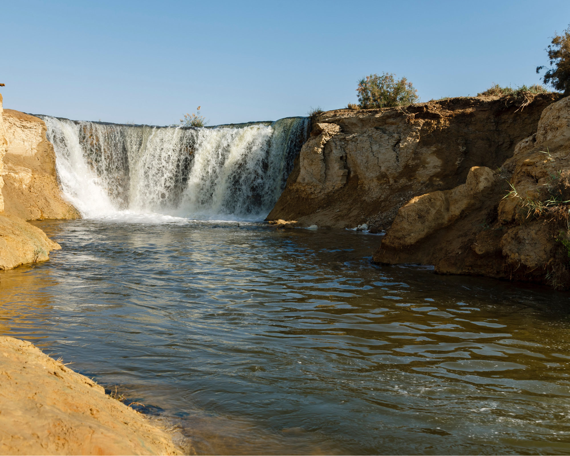 Wadi El Rayan waterfalls surrounded by desert scenery in Fayoum, Egypt